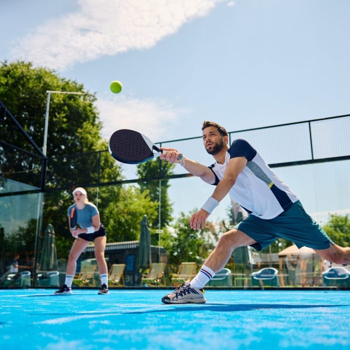 Young,Athlete,Playing,Padel,In,Mixed,Doubles,On,Outdoor,Court.